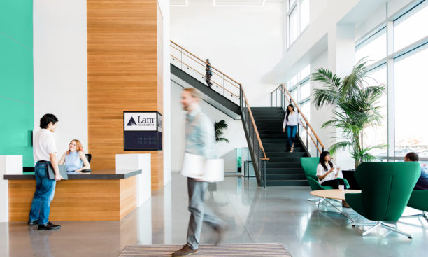 People walking around in Lam office lobby