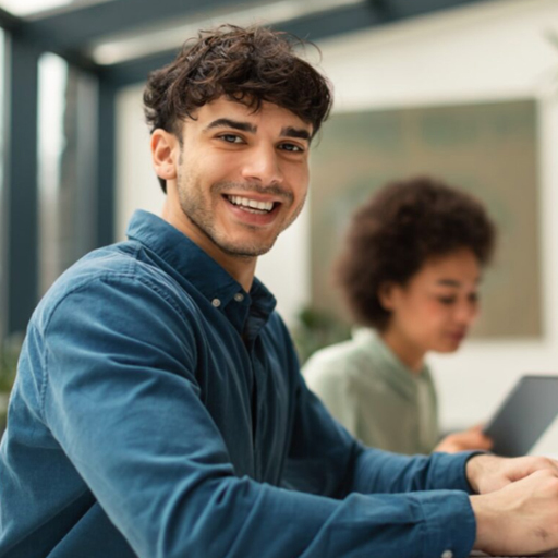 Person sitting at a desk and smiling
